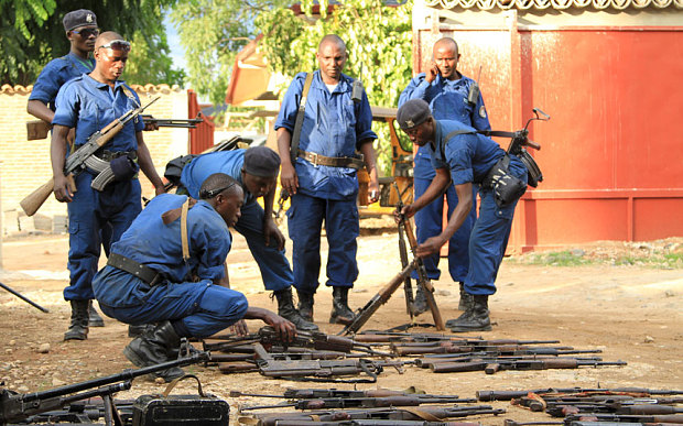 Burundian police collect weapons from suspected fighters in Bujumbura, Burundi. Image Courtesy of telegraph.co.uk.