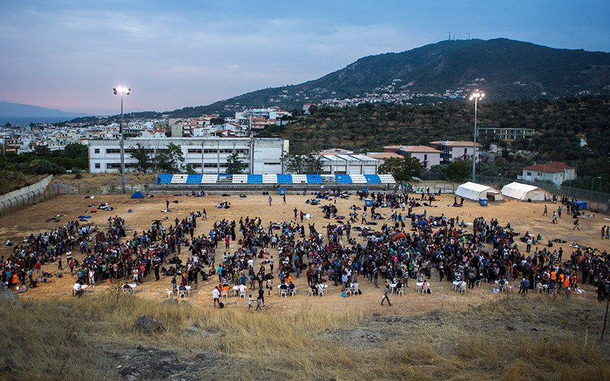 Refugees register at a football stadium in Mytilene, on the Greek island of Lesbos. Image Courtesy of telegraph.co.uk